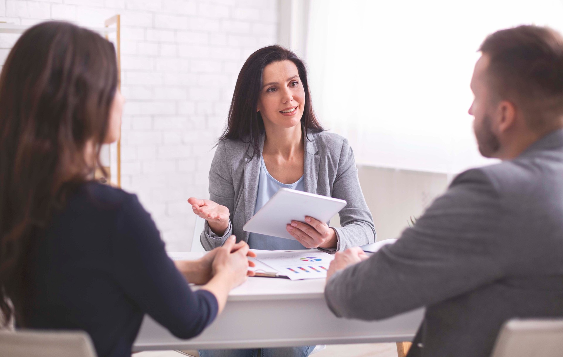 Professional Consulting Session in Modern Office With Two Clients Discussing Future Plans